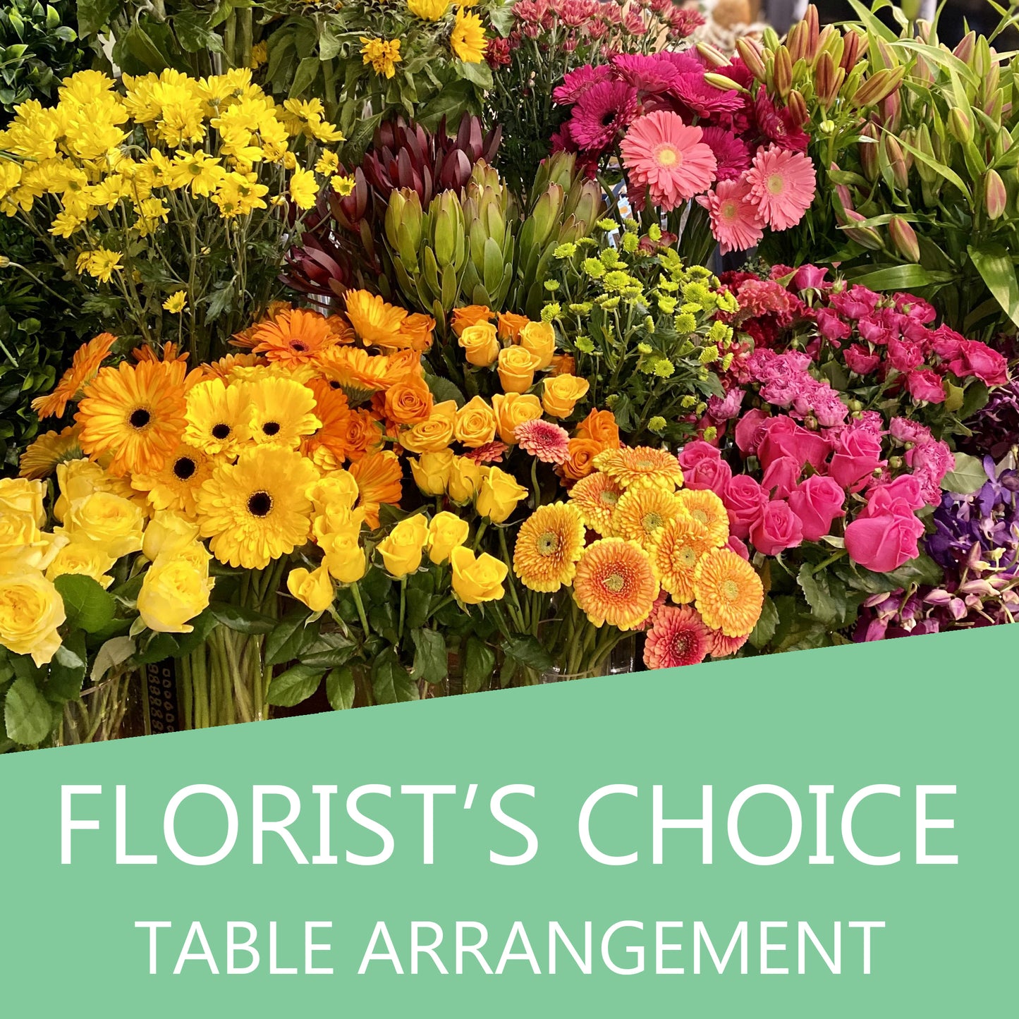 Colorful florist's choice flower table arrangement by Cattle Dog Café and Florist featuring mixed fresh flowers on a table.
