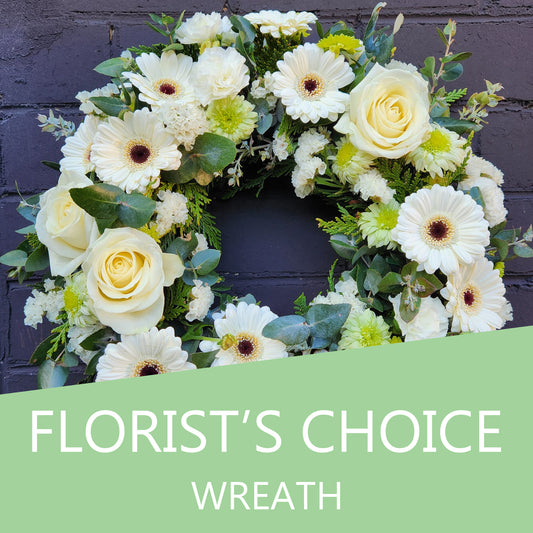 Beautiful florist's choice flower wreath featuring vibrant seasonal blooms, arranged in a circular design, by Cattle Dog Café and Florist.